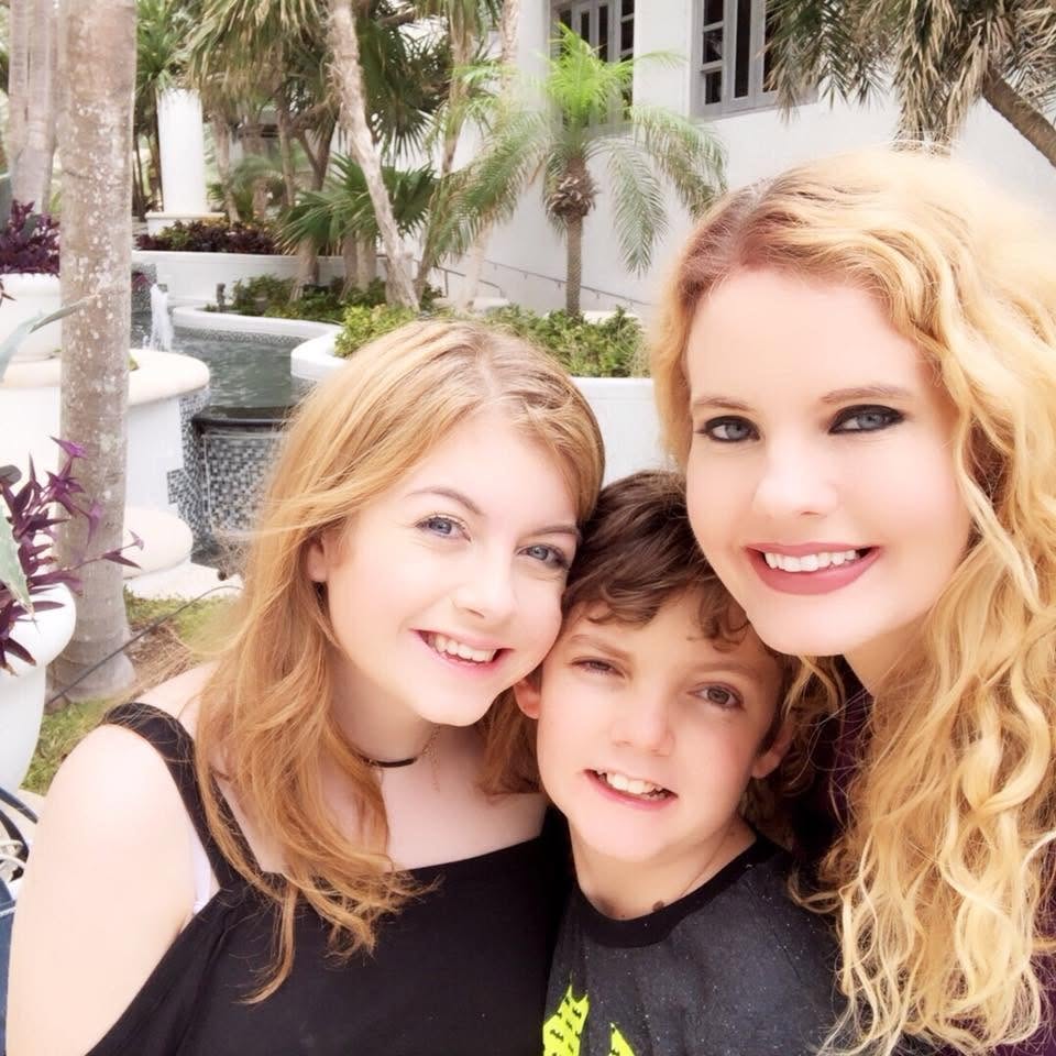 A smiling family selfie from earlier years